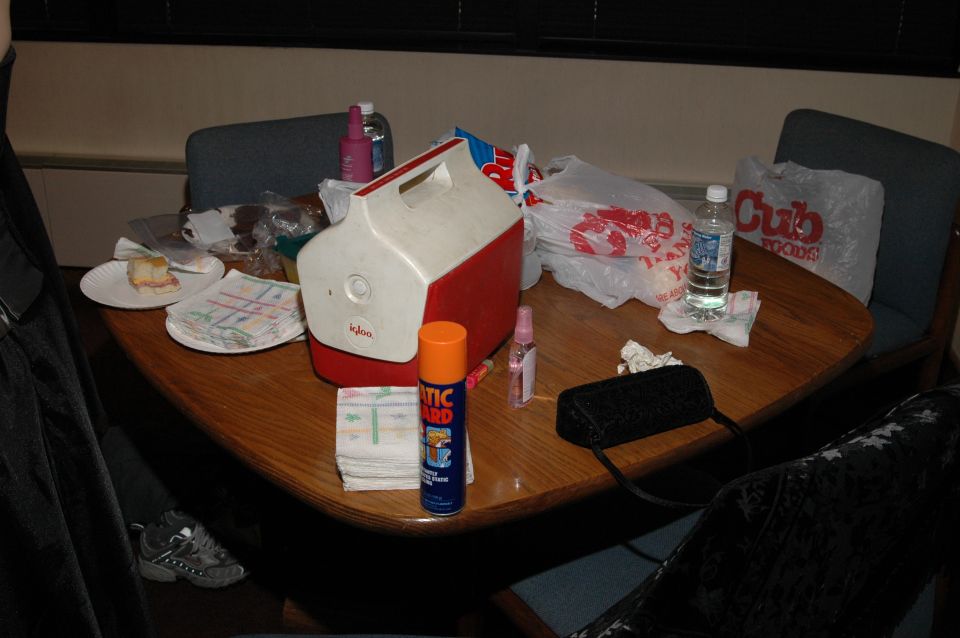 Table with Igloo cooler, food, drinks, and a can of Static Guard