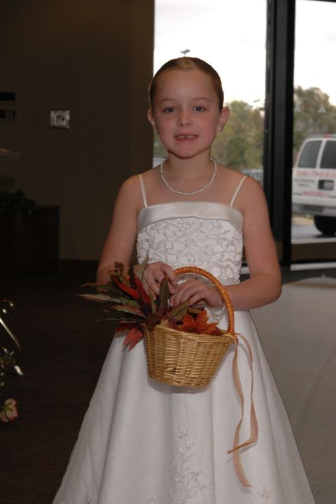 1985 Ford Crown Victoria LTD - A young girl dressed for a wedding holds a basket filled with colorful leaves.