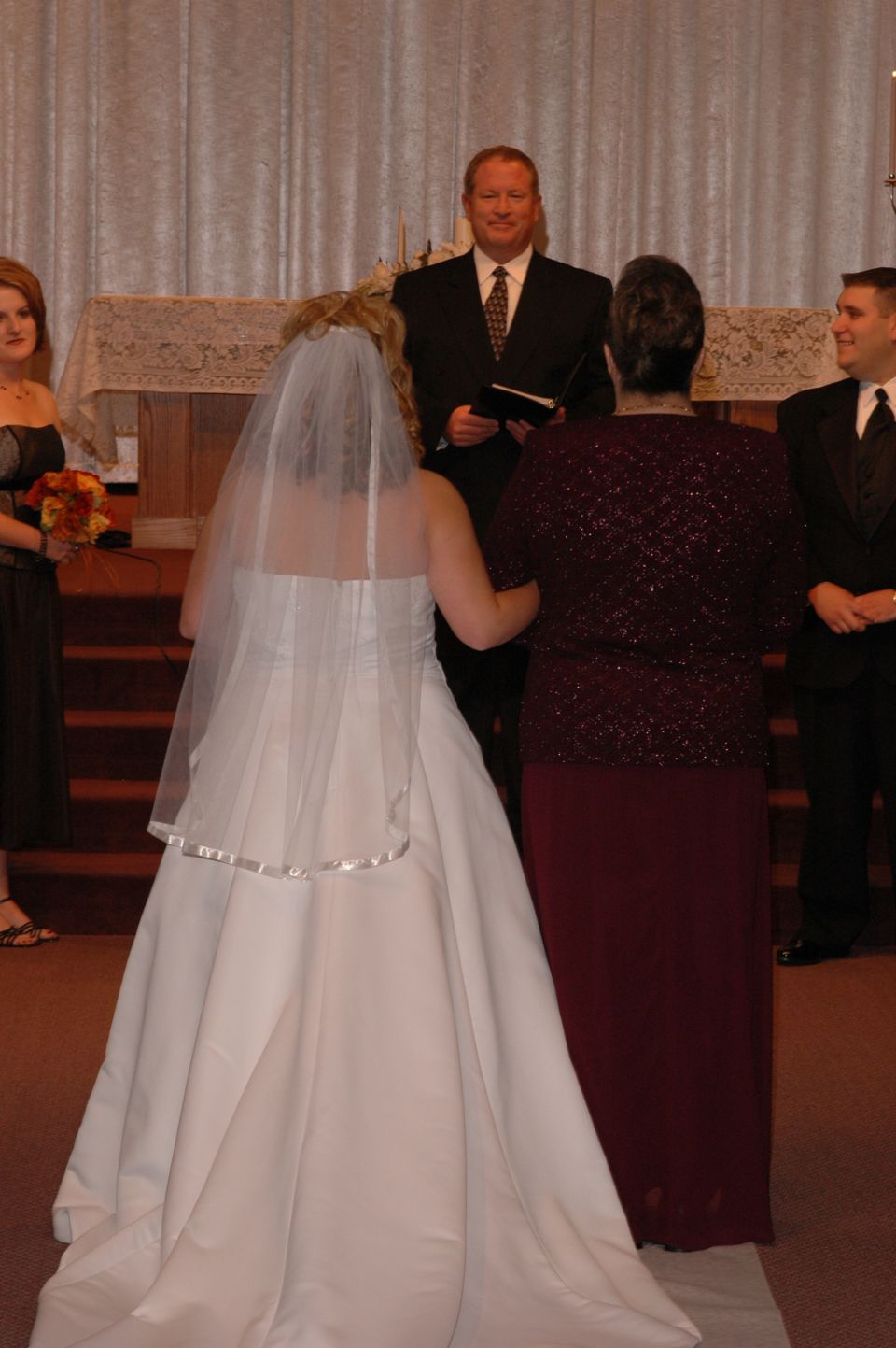 Wedding ceremony with bride, groom, officiant, and guests