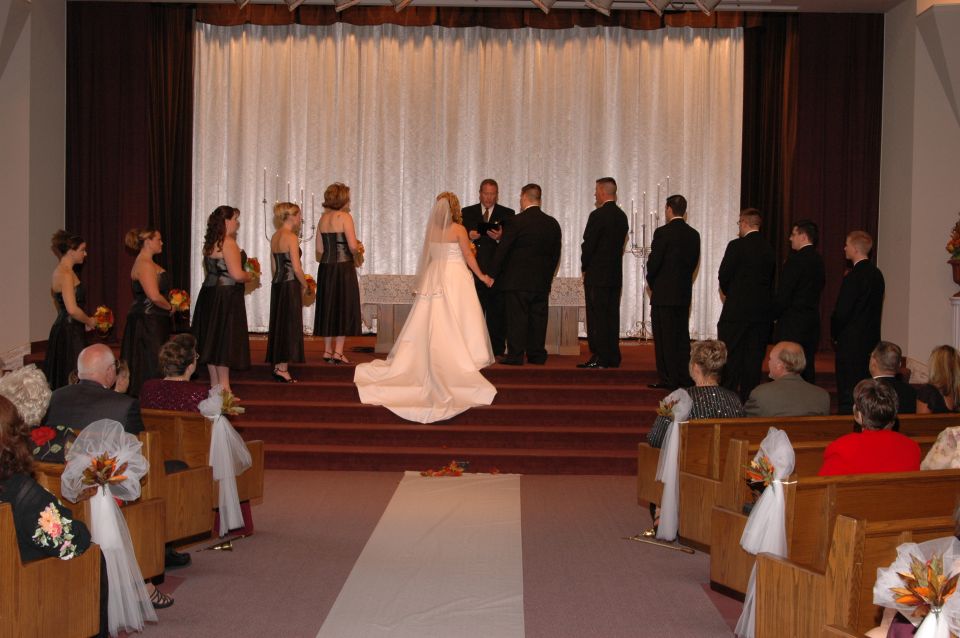 Wedding ceremony with bride, groom, wedding party, and guests