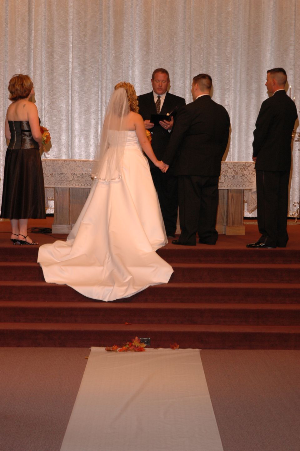 Wedding ceremony with bride, groom, officiant, and wedding party