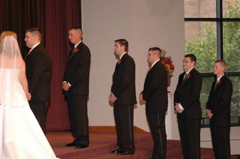 1985 Ford Crown Victoria LTD - A wedding party stands in formal attire during a ceremony.
