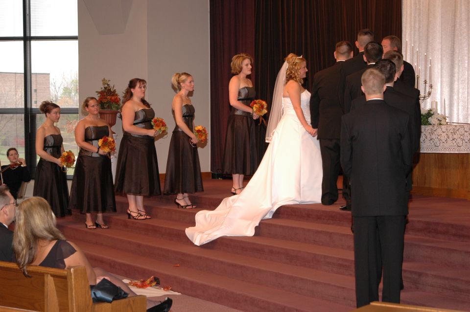 Wedding ceremony with bride, groom, bridesmaids, and groomsmen on steps