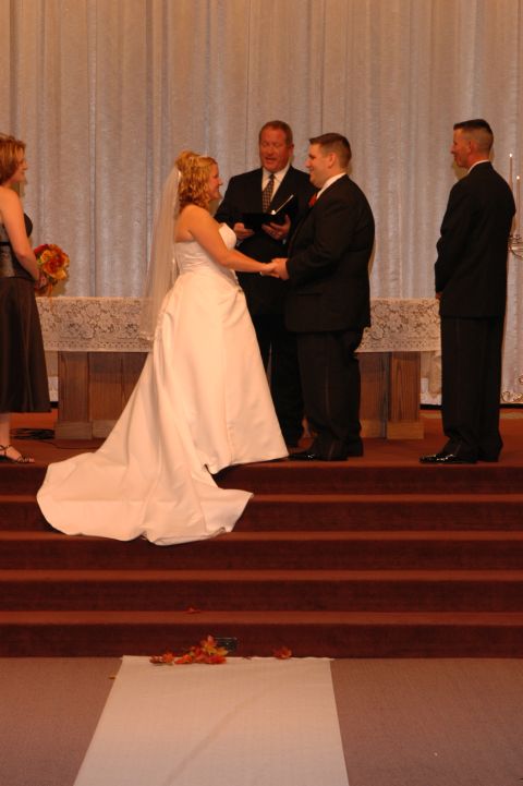 1985 Ford Crown Victoria LTD - A wedding ceremony takes place with the bride and groom exchanging vows at the altar.