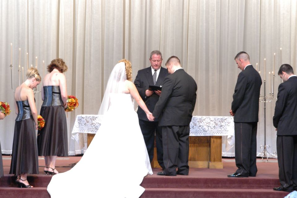 Wedding ceremony with bride, groom, officiant, and wedding party