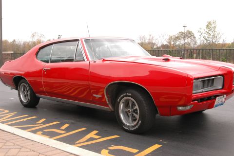 1985 Ford Crown Victoria LTD - This red 1969 Pontiac GTO is a classic muscle car.
