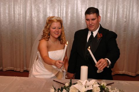 1985 Ford Crown Victoria LTD - Bride and groom participate in a unity candle lighting ceremony.