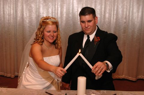 1985 Ford Crown Victoria LTD - A bride and groom participate in a unity candle lighting ceremony.