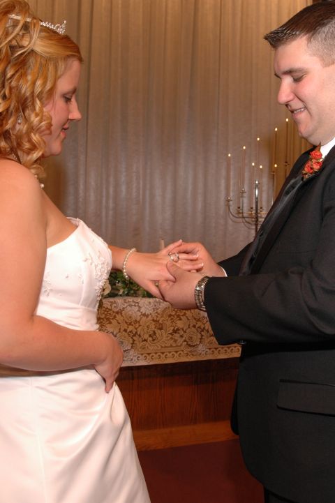 1985 Ford Crown Victoria LTD - A couple exchanges wedding rings during their ceremony.