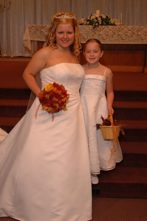 1985 Ford Crown Victoria LTD - A bride and a flower girl pose for a photo during a wedding ceremony.