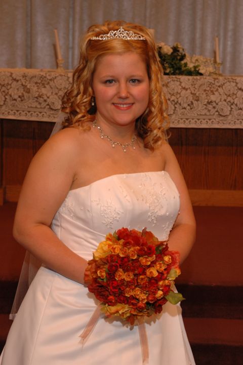 1985 Ford Crown Victoria LTD - A bride smiles while holding a bouquet in front of an altar.