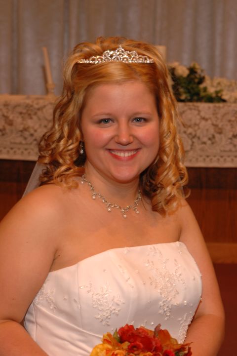 1985 Ford Crown Victoria LTD - Bride smiles for the camera, adorned with a tiara and jewelry on her wedding day.