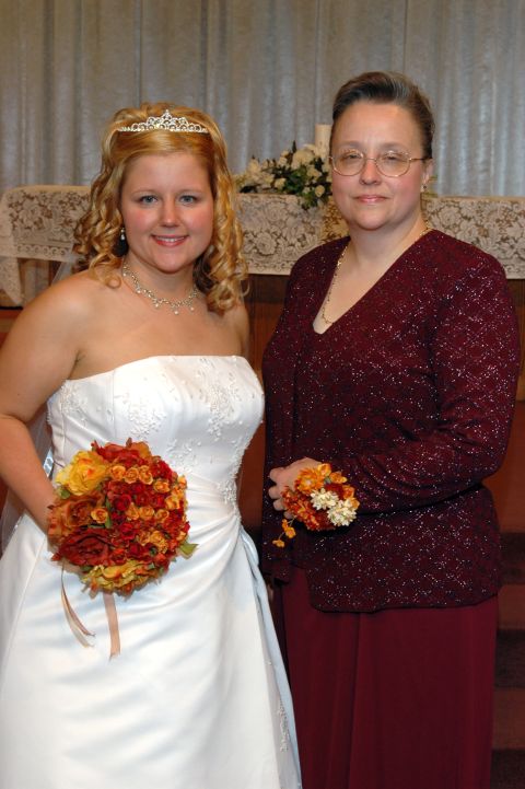 1985 Ford Crown Victoria LTD - Bride and her mother pose for a wedding photo indoors.