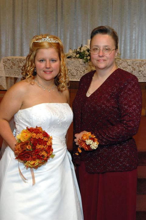 1985 Ford Crown Victoria LTD - A bride and her mother pose for a photo during a wedding ceremony.