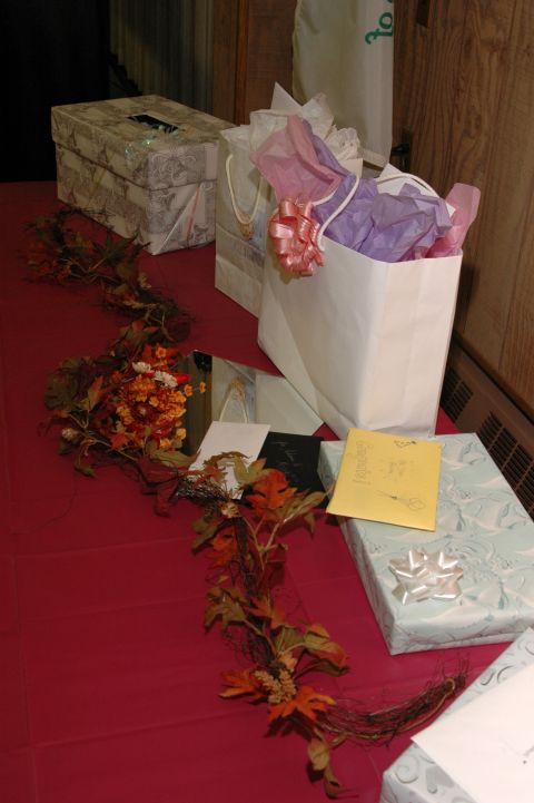 1985 Ford Crown Victoria LTD - Gifts and decorations are laid out on a table for a wedding celebration.
