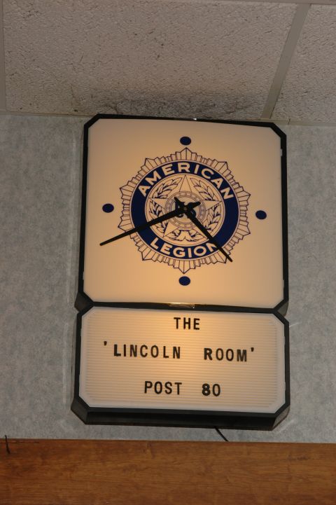1985 Ford Crown Victoria LTD - Clock with American Legion emblem hangs above a sign for 'The Lincoln Room Post 80'.