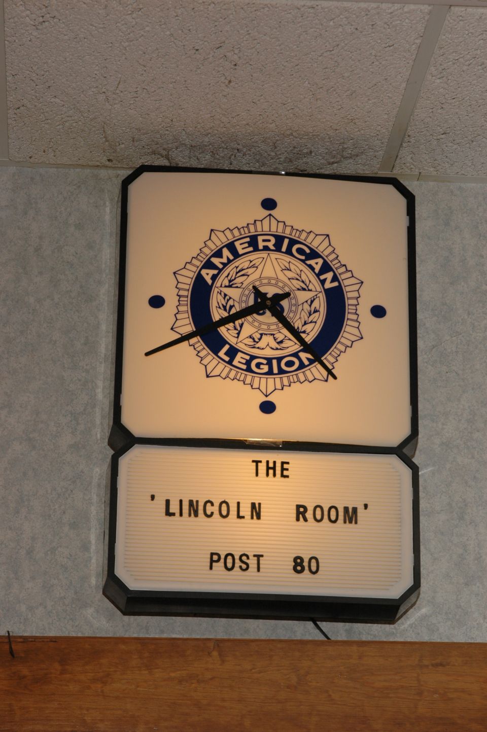 American Legion clock with 'The Lincoln Room Post 80' sign below it