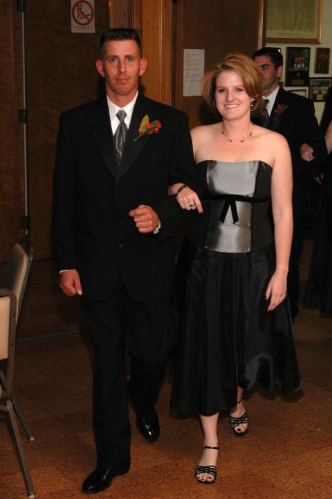 1985 Ford Crown Victoria LTD - A couple walks together, dressed formally for an event.