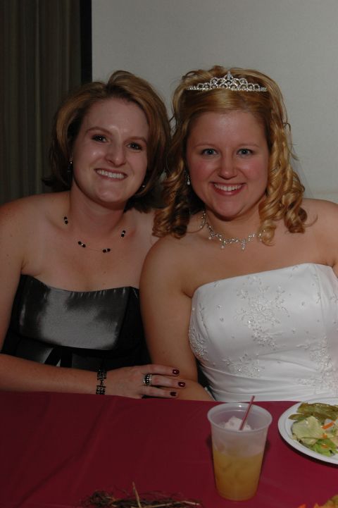 1985 Ford Crown Victoria LTD - A bride and another woman pose for a photo at a formal event, possibly a wedding reception.