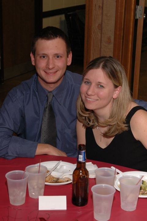 1985 Ford Crown Victoria LTD - A man and woman smile at the camera while seated at a table during an event.