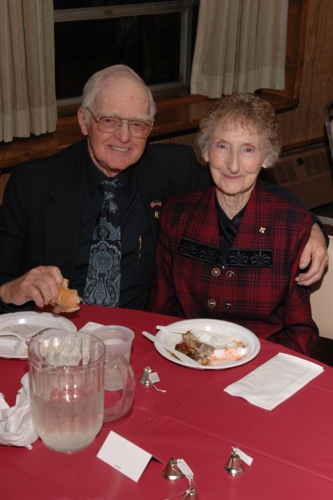 1985 Ford Crown Victoria LTD - An elderly couple poses for a photo at a table set for a meal.