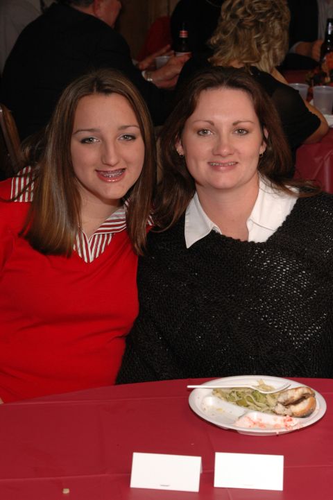 1985 Ford Crown Victoria LTD - A mother and daughter pose for a photo at a formal event, seated at a table with a partially eaten meal.