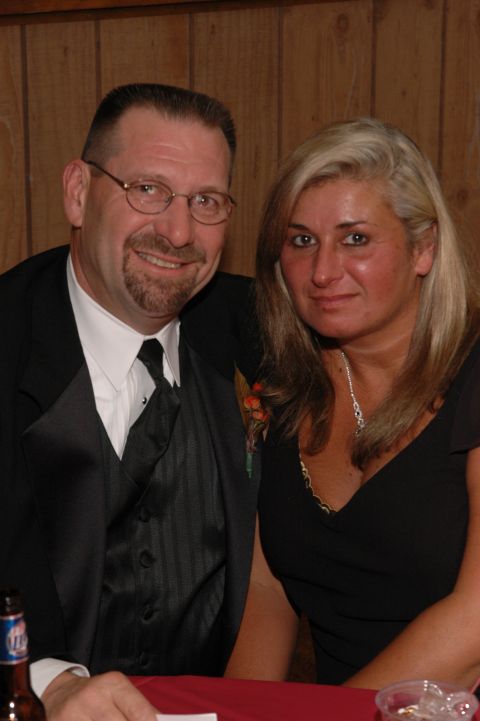 1985 Ford Crown Victoria LTD - A man and woman smile for a photo while seated at a table, possibly during a formal event.