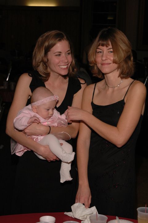 1985 Ford Crown Victoria LTD - Two women and a baby are gathered together, possibly at an event.