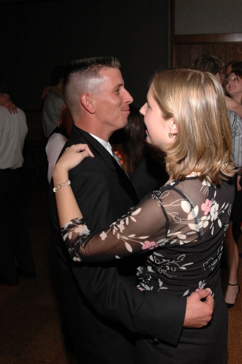 1985 Ford Crown Victoria LTD - A couple shares a dance at an event, with other guests blurred in the background.