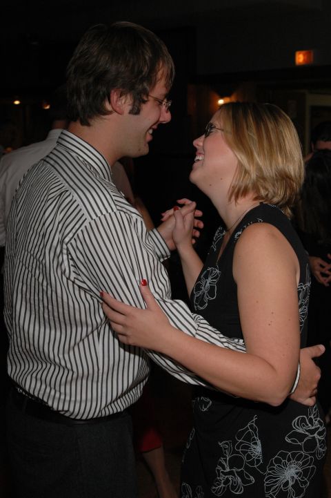 1985 Ford Crown Victoria LTD - A couple shares a joyful moment while dancing together at a formal event.