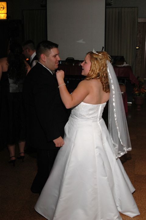 1985 Ford Crown Victoria LTD - A bride and groom share a moment on the dance floor during their wedding reception.