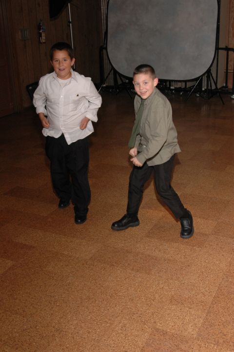 1985 Ford Crown Victoria LTD - Two boys dressed up for an event stand on a cork floor with studio equipment in the background.