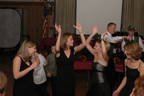 1985 Ford Crown Victoria LTD - A wedding reception is in full swing with guests dancing and enjoying the celebration.