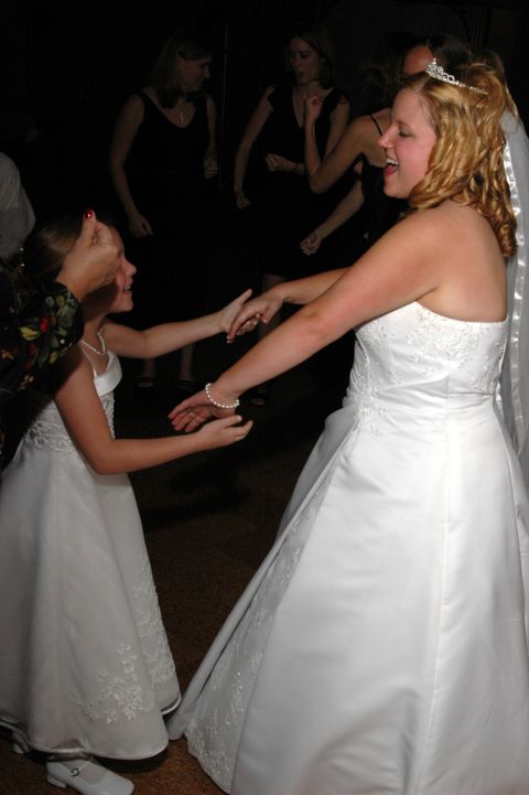 1985 Ford Crown Victoria LTD - A bride and a flower girl share a dance on the reception floor.