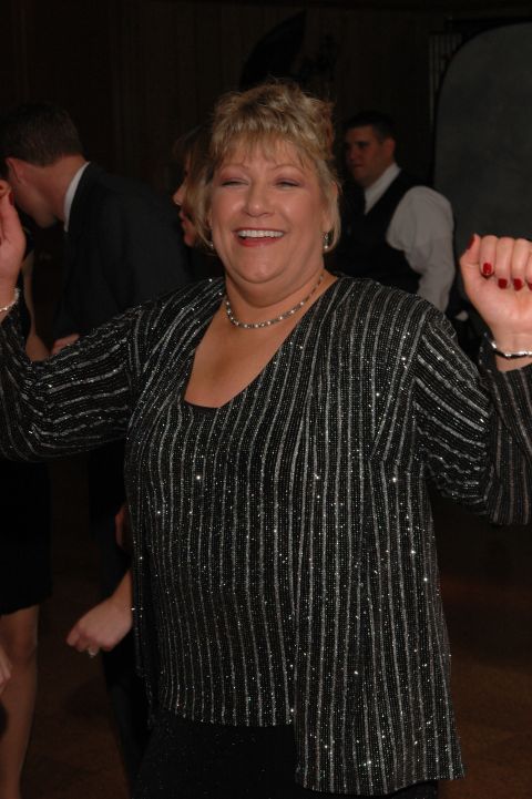 Woman in sparkly top dancing at a wedding reception