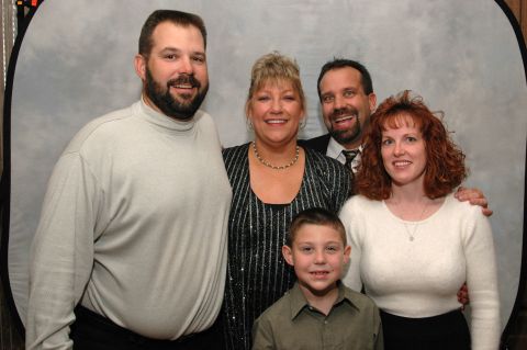 Group photo of five people posing for a studio portrait