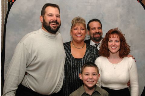 Family posing for a portrait in front of a grey backdrop