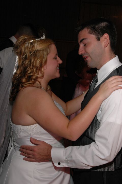 Bride with tiara and groom dancing closely