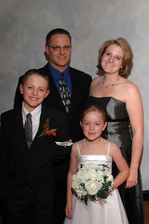 Family of four posing for a wedding photo