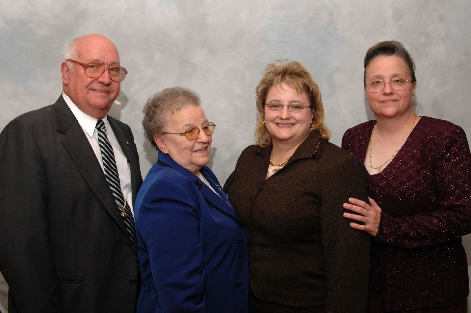 four people, two men and two women, posing for a photo