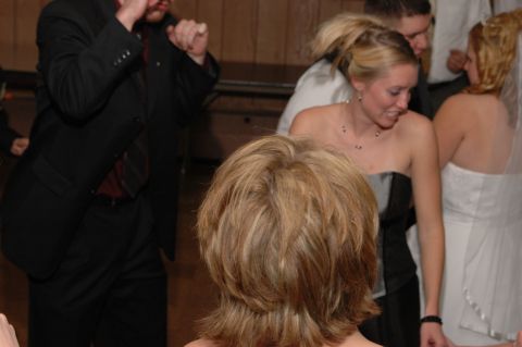People in formal wear at what looks like a wedding reception