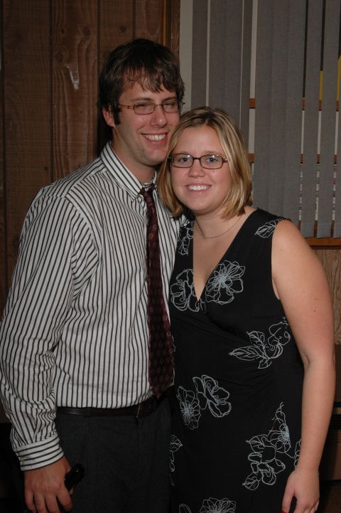 Man in striped shirt and tie with woman in floral dress smiling