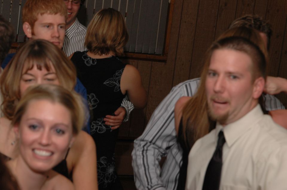 people in a room, some looking at the camera, others interacting