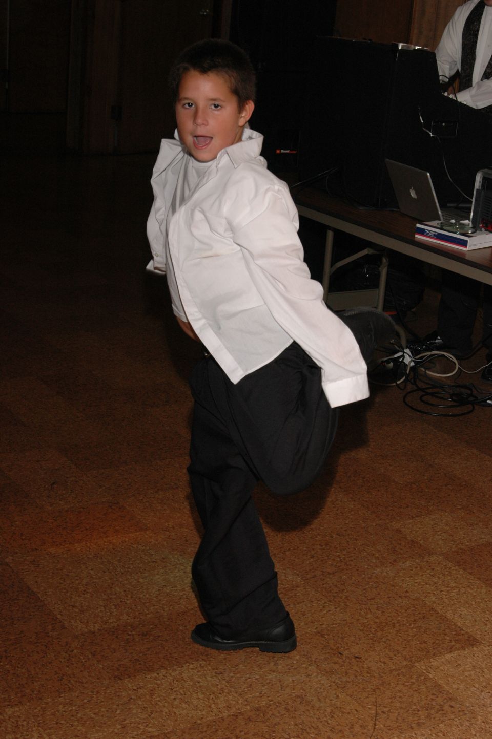 Boy in white shirt and black pants dancing