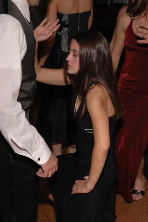 People in formal attire dancing at an event