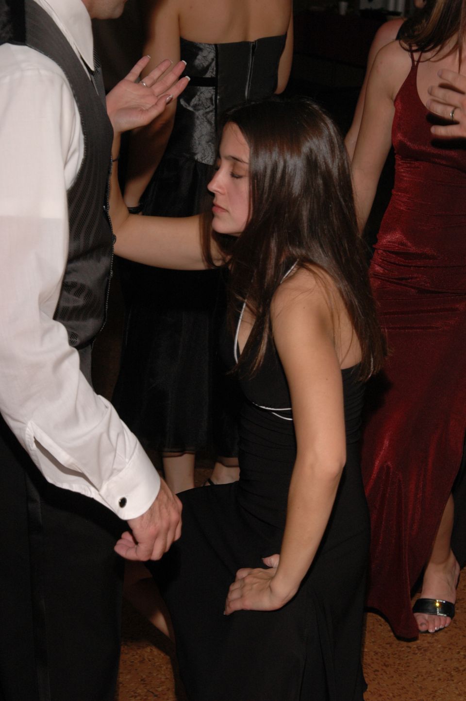 People in formal attire dancing at an event