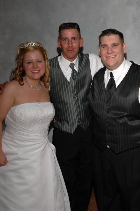 Bride and two groomsmen posing for a photo