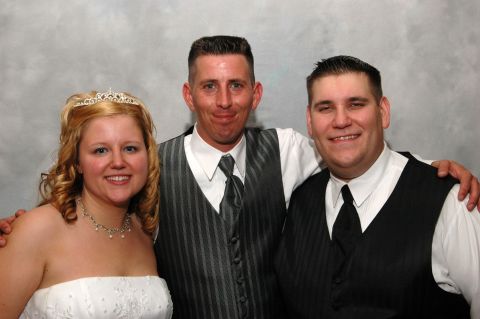 Bride with tiara, groom, and another man in formal wear