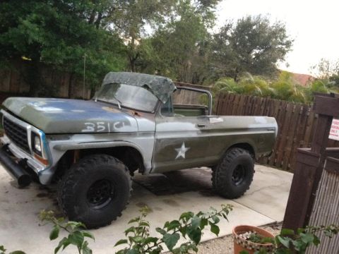 1979 Ford Bronco - Customized 1978 Ford Bronco with military-style paint and large off-road tires.