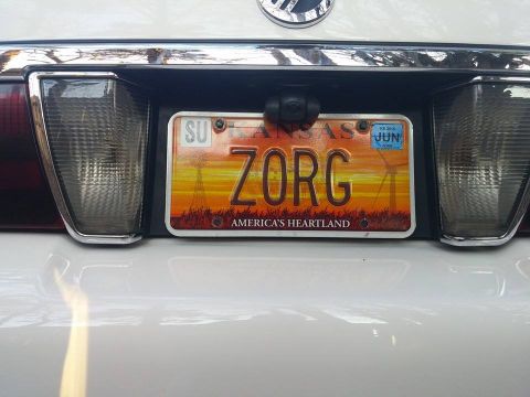 2000 Mercury Grand Marquis - The rear of a vehicle displays a Kansas license plate with a sunset graphic and the custom text ZORG.